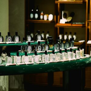 An elegant arrangement of perfume bottles in a boutique store in Shanghai, China. Sophisticated ambiance with selective lighting.