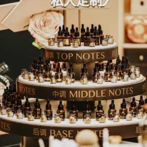 Luxurious perfume display with top, middle, and base notes bottles indoors.